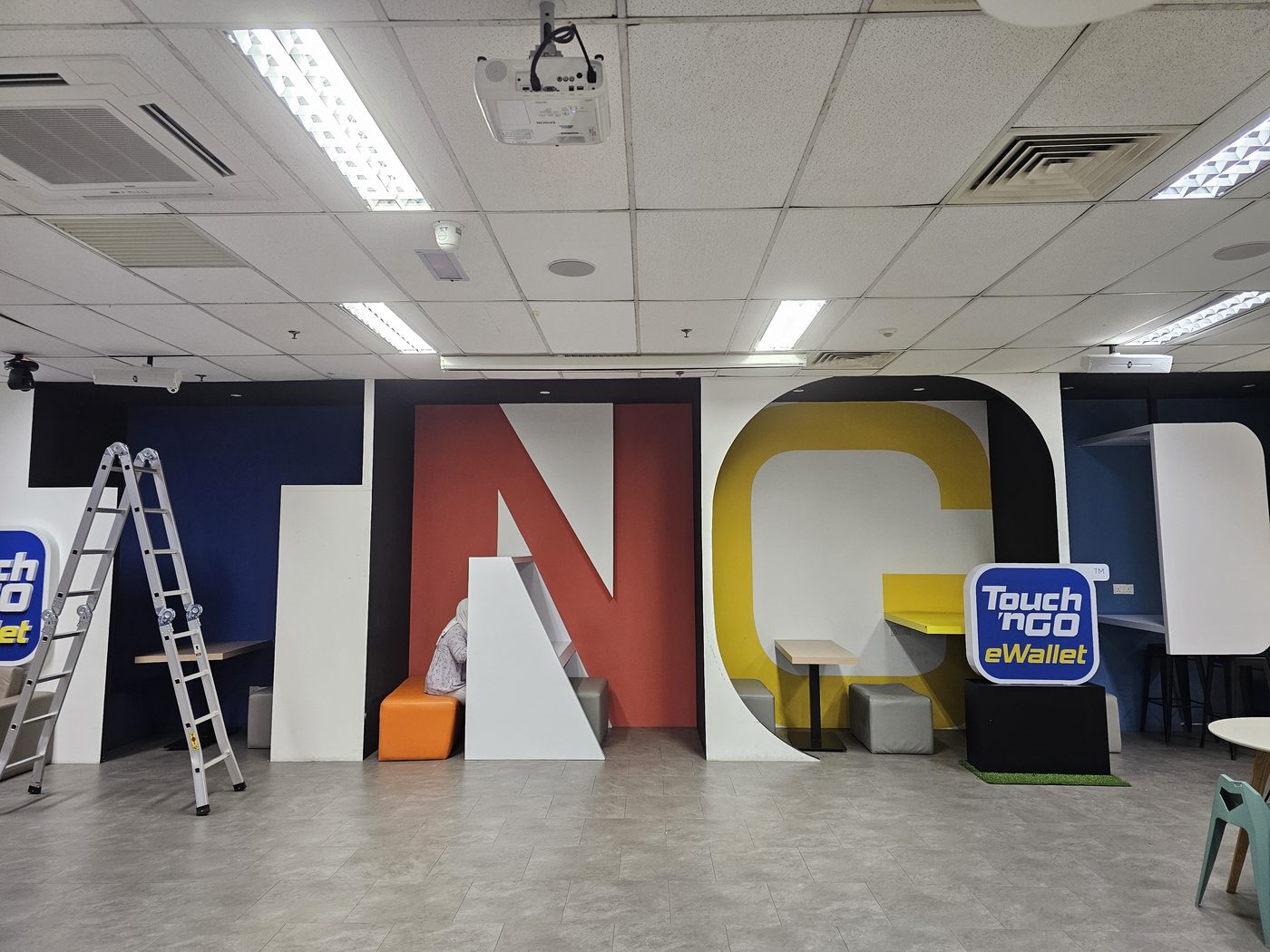 Touch 'n Go eWallet branded office event space with projector and AV installation
