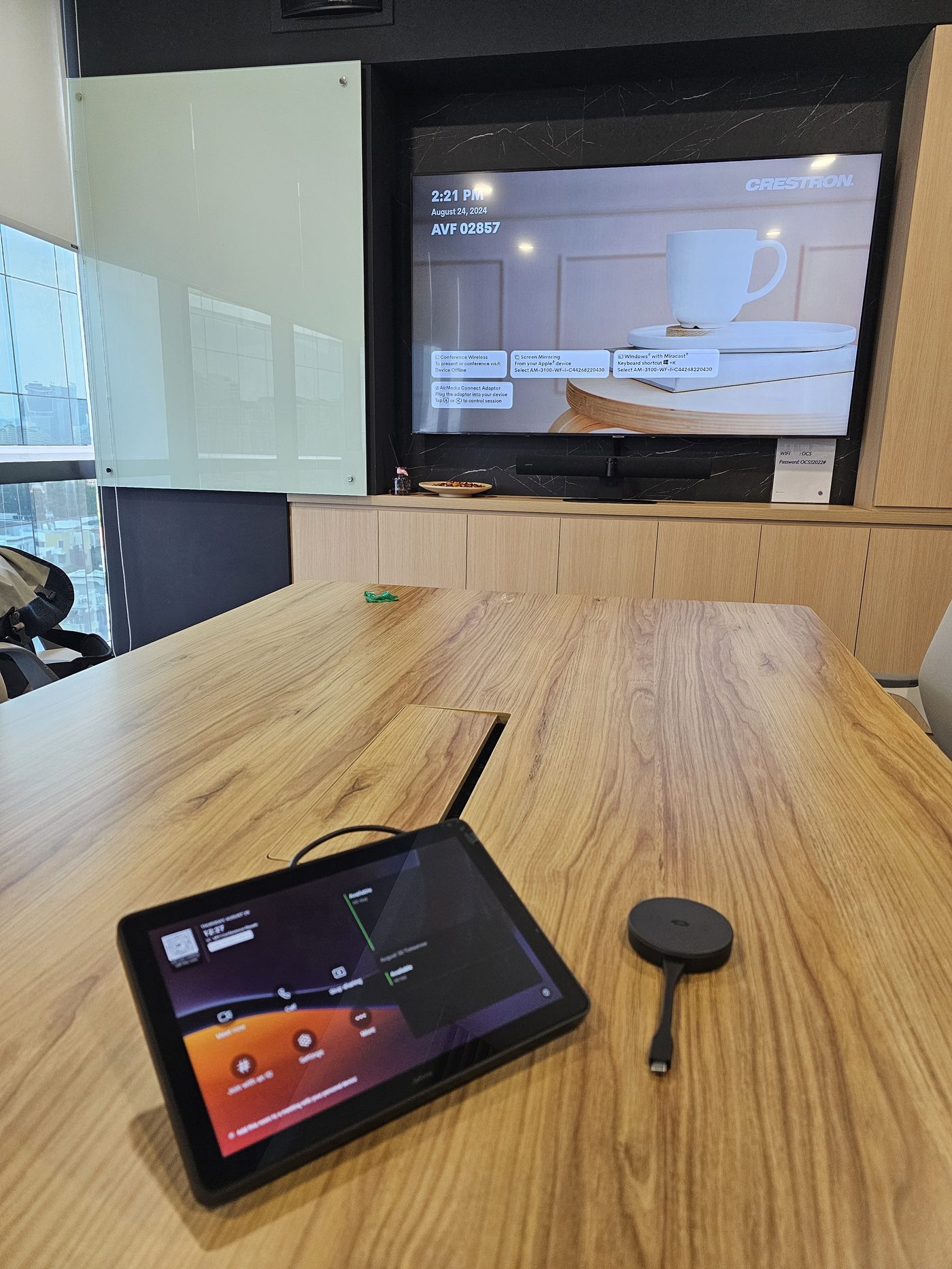 Boardroom troubleshooting visit with Jabra soundbar, touch panel and laptop on table
