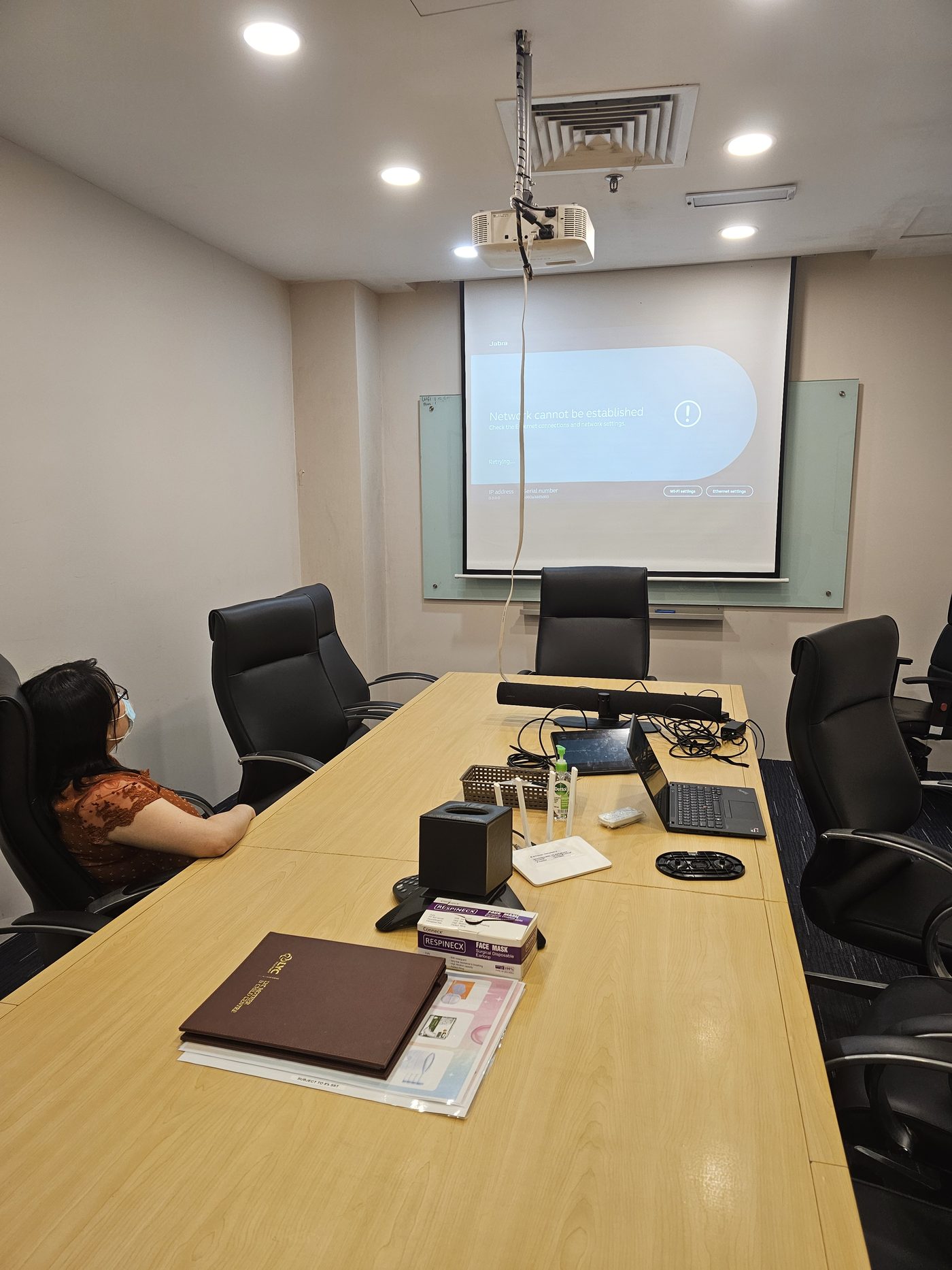 Wide angle of boardroom during on-site network troubleshooting visit
